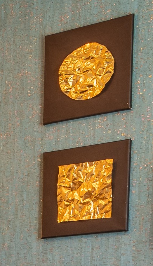 Gold foil canvases on teal shimmer wall