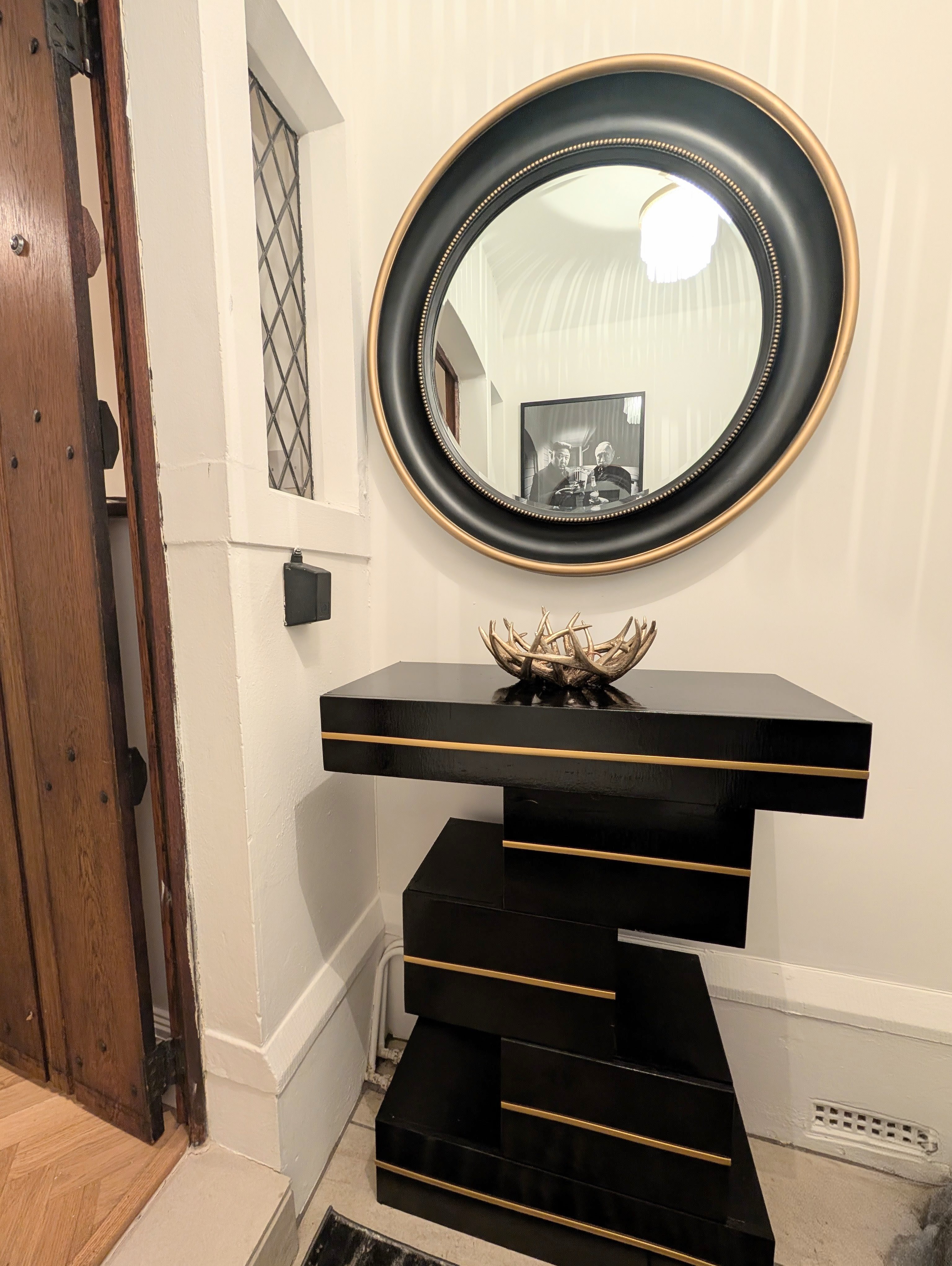 Black console table with round mirror