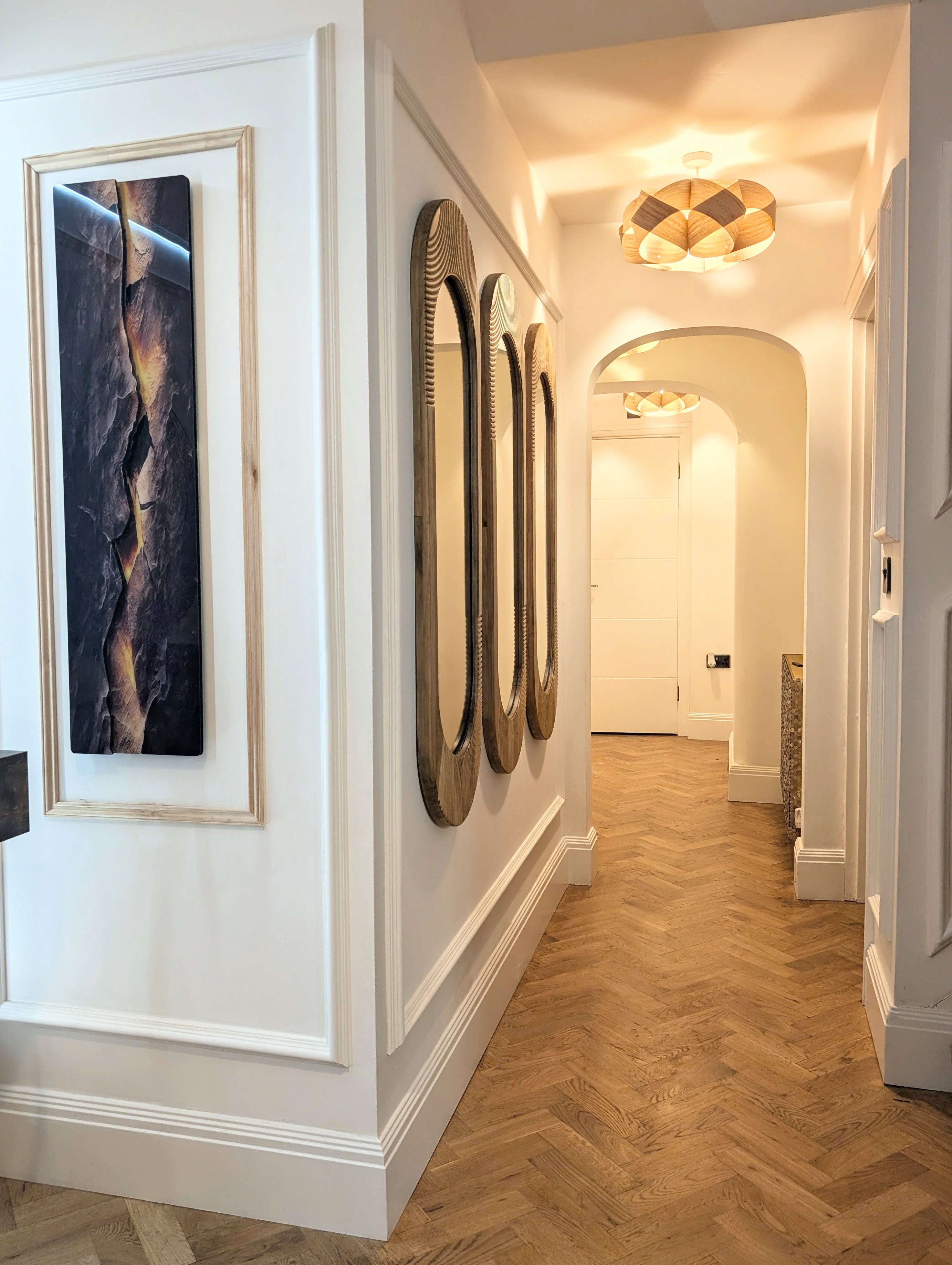The Grand Hallway — oval mirrors and arch corridor