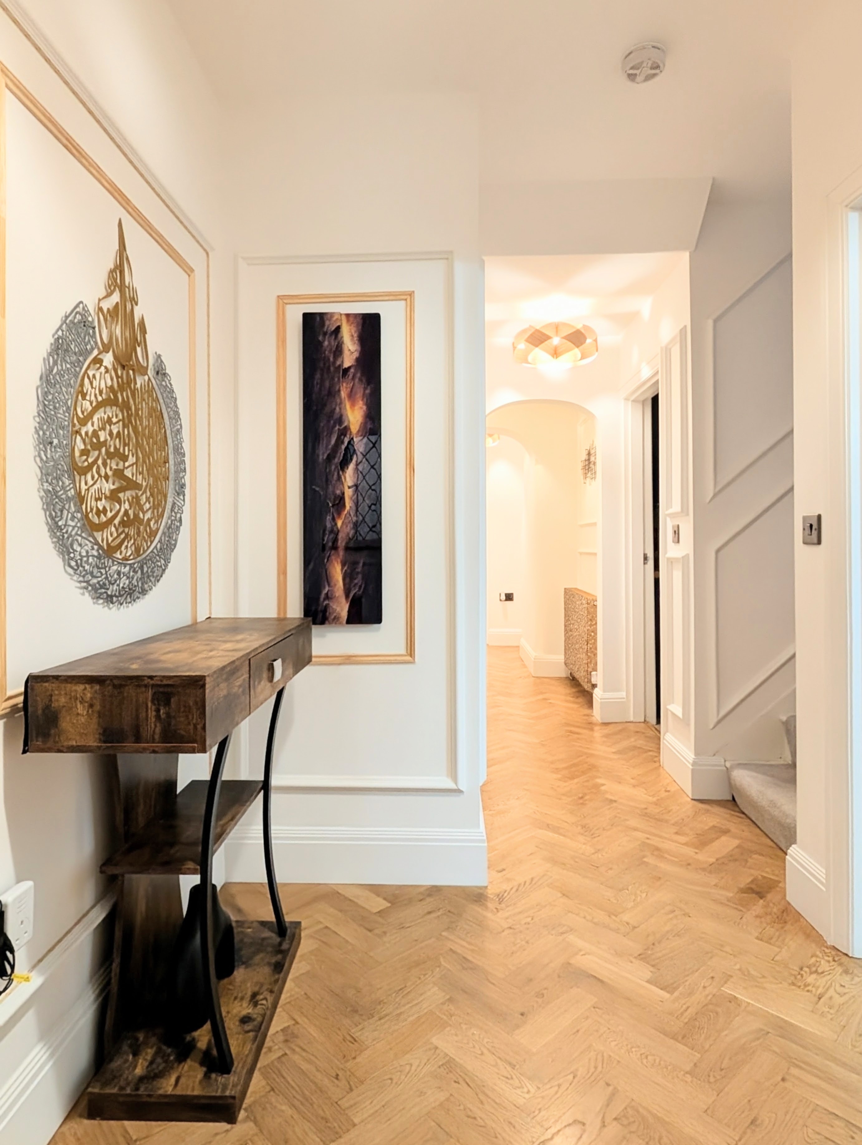 Hallway with herringbone floor and calligraphy art
